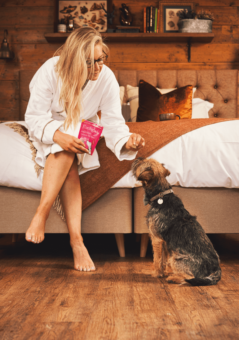 Woman giving dog a treat